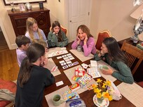 Playing game on the dining room table that seats 10