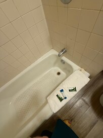 Edge of the tub had been repaired with dingy caulking. Moldy!