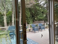 Large backyard deck, seating areas and table, grill