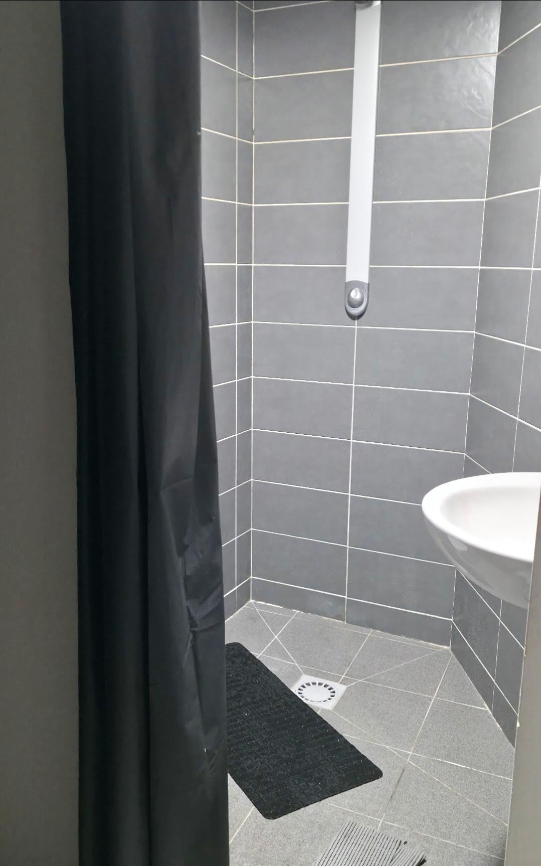 a plastic curtain separates the room from the toilet and shower