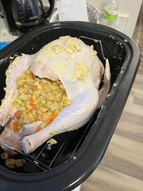 Ready to cook. Counter space in the kitchen was at a premium so placed roaster on ironing board in a bedroom.