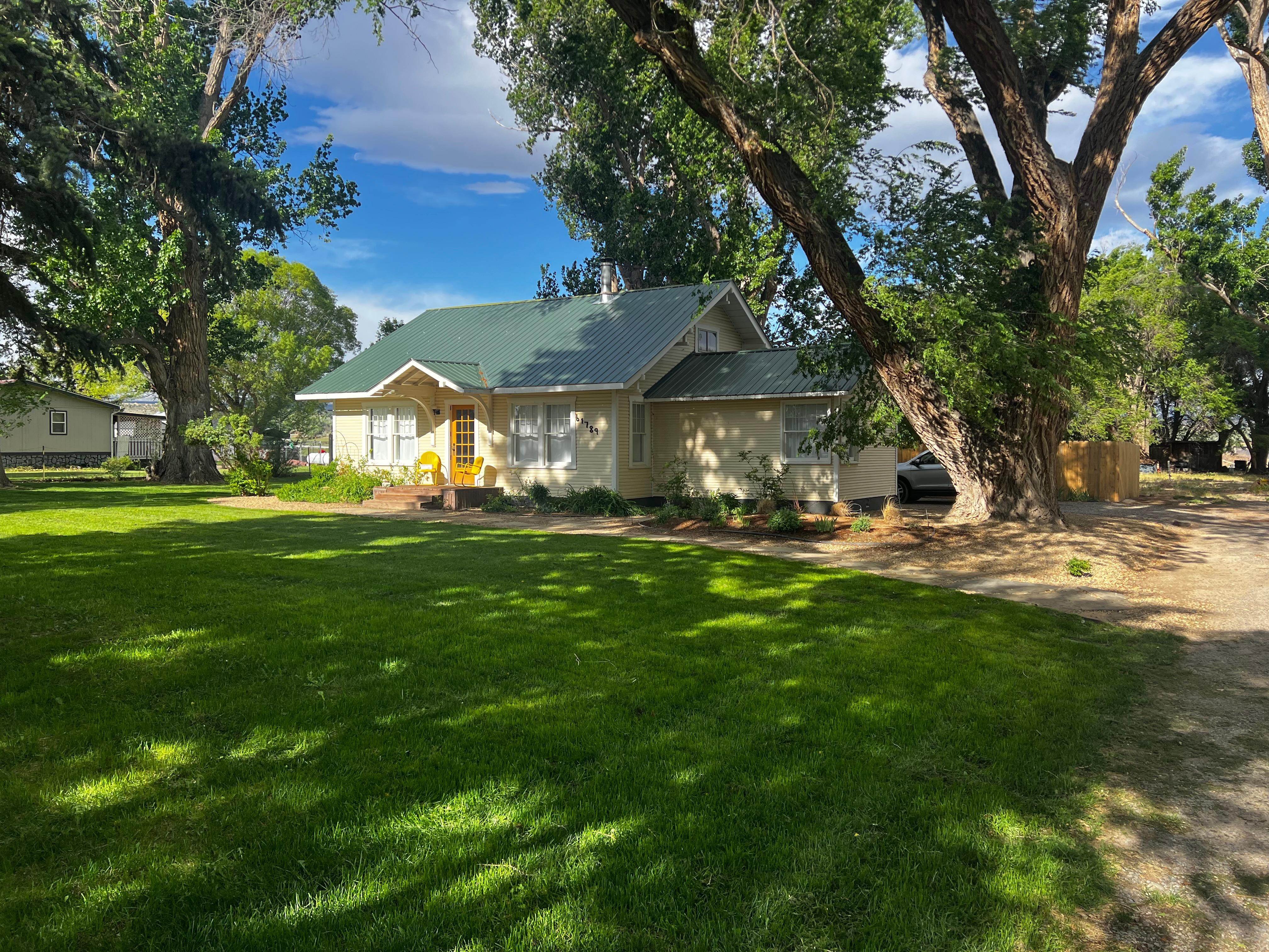Well kept yard with an irrigation creek in front..