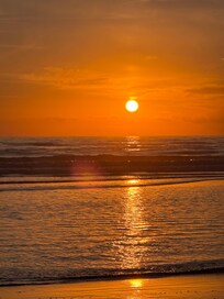 A beautiful sunset on the beach in front of the house.
