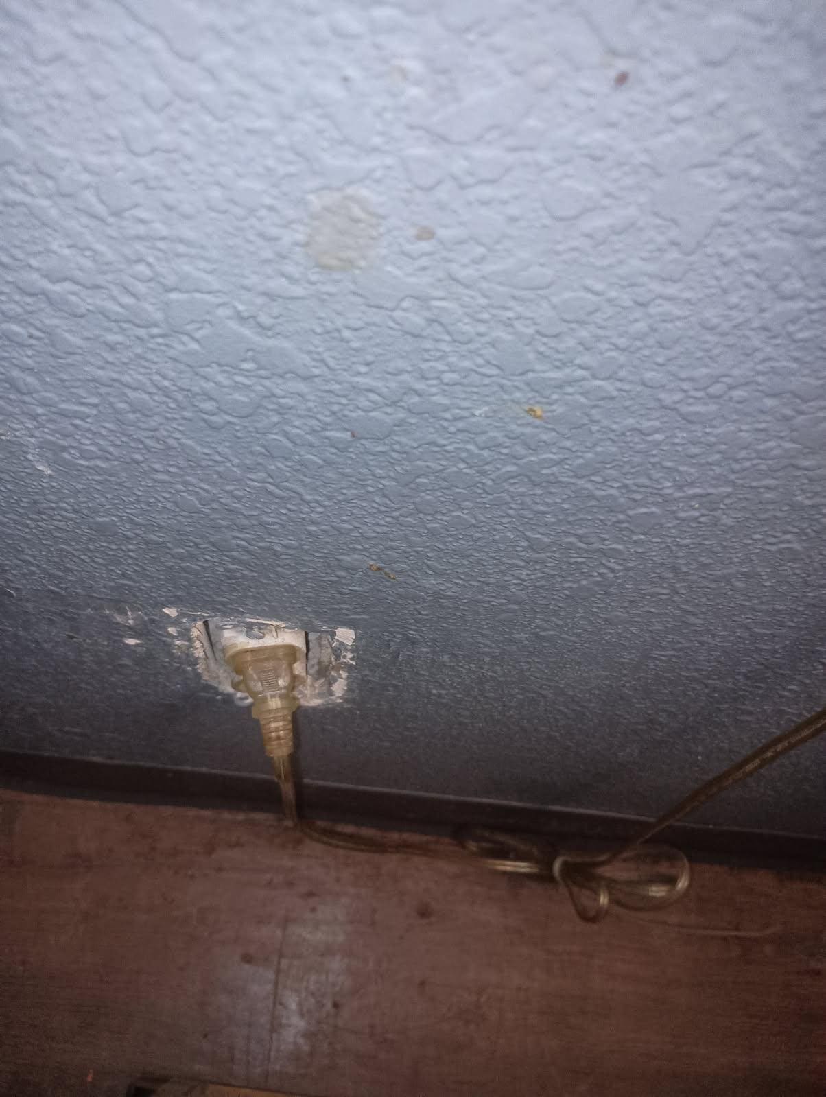 Exposed outlet behind nightstand
