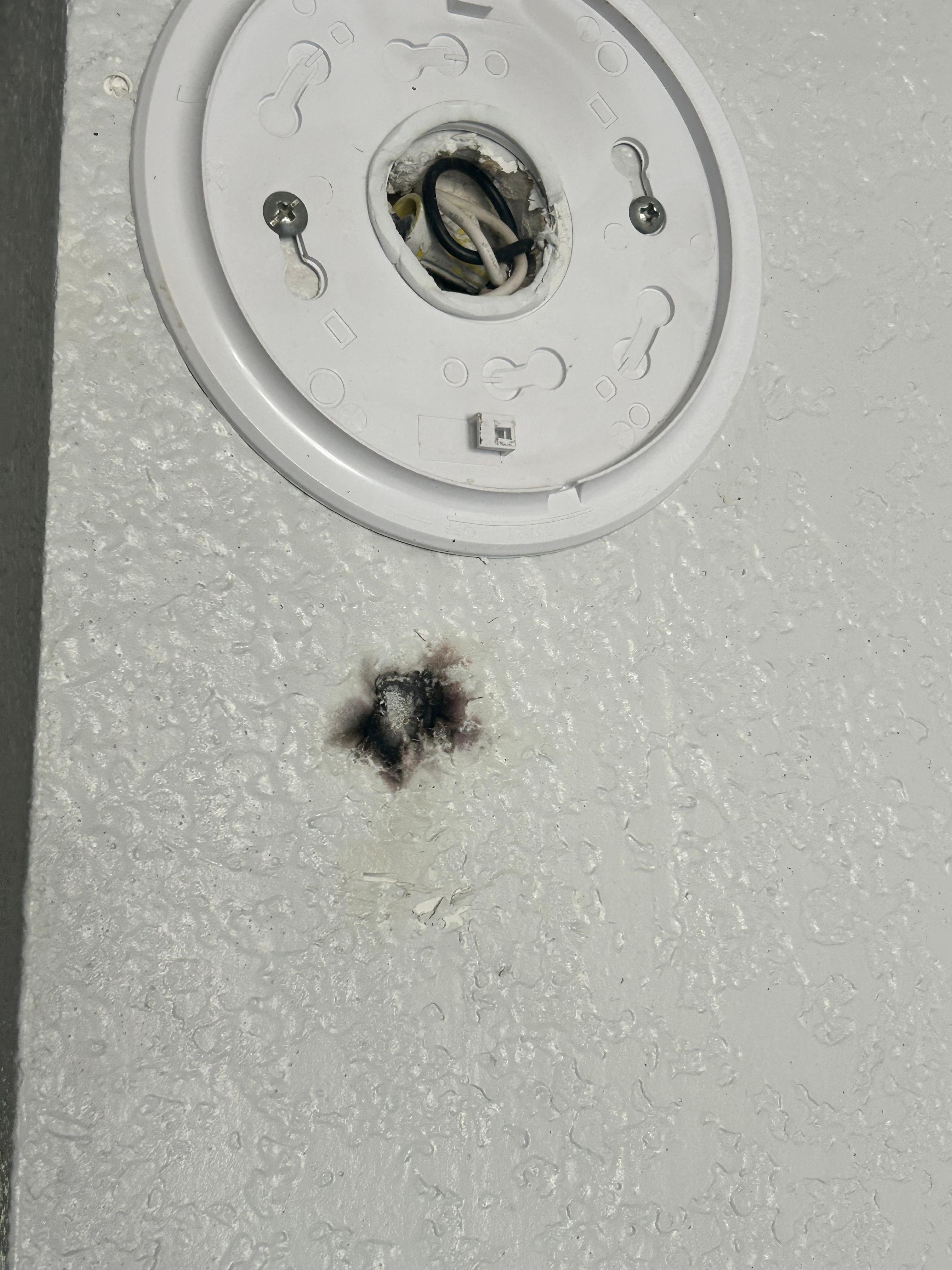Burn mark below smoke detector, that u found battery less in a drawer 