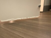 Bottom of bathroom door / looks like it flooded