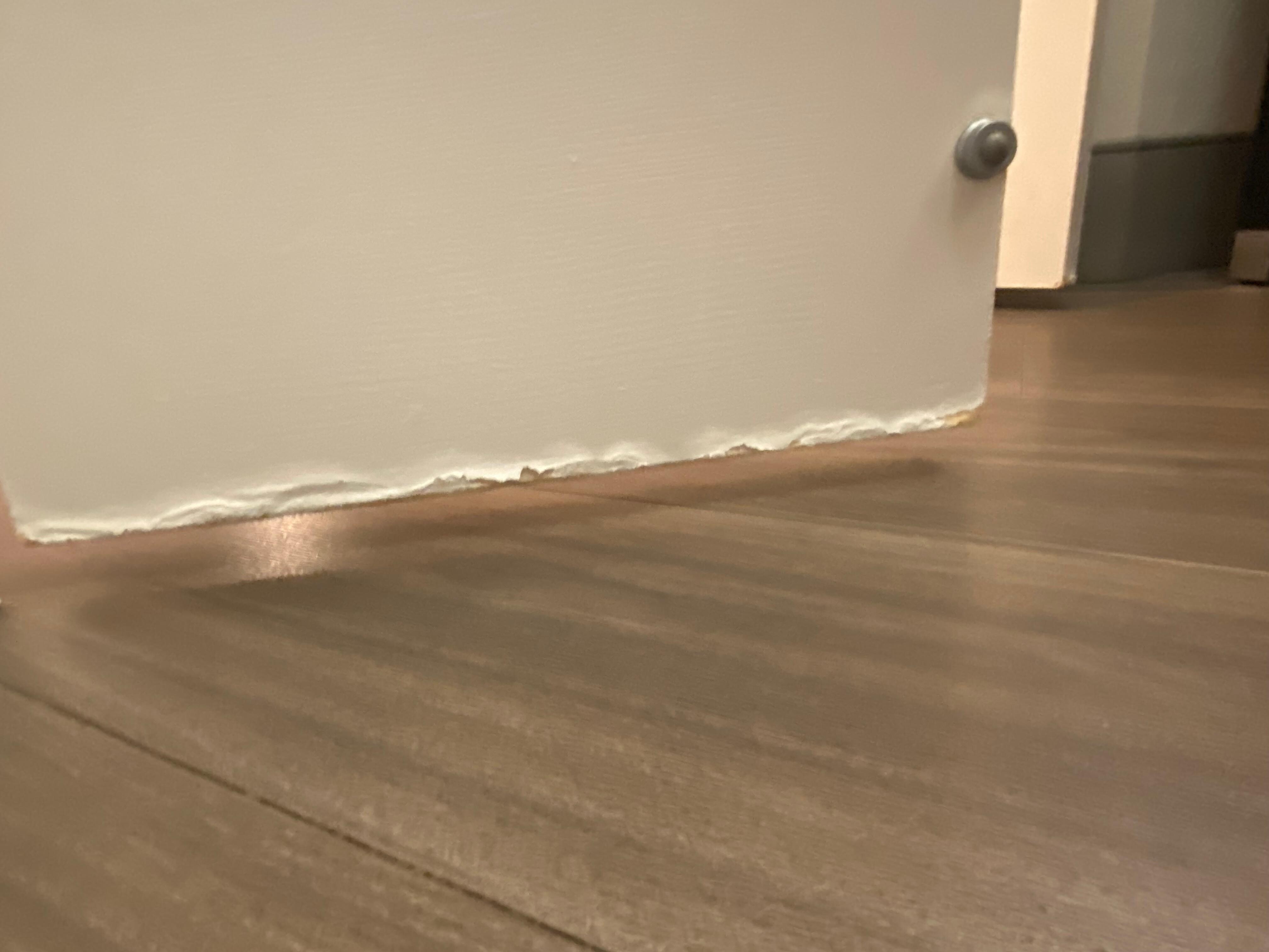 Bottom of bathroom door / looks like it flooded 