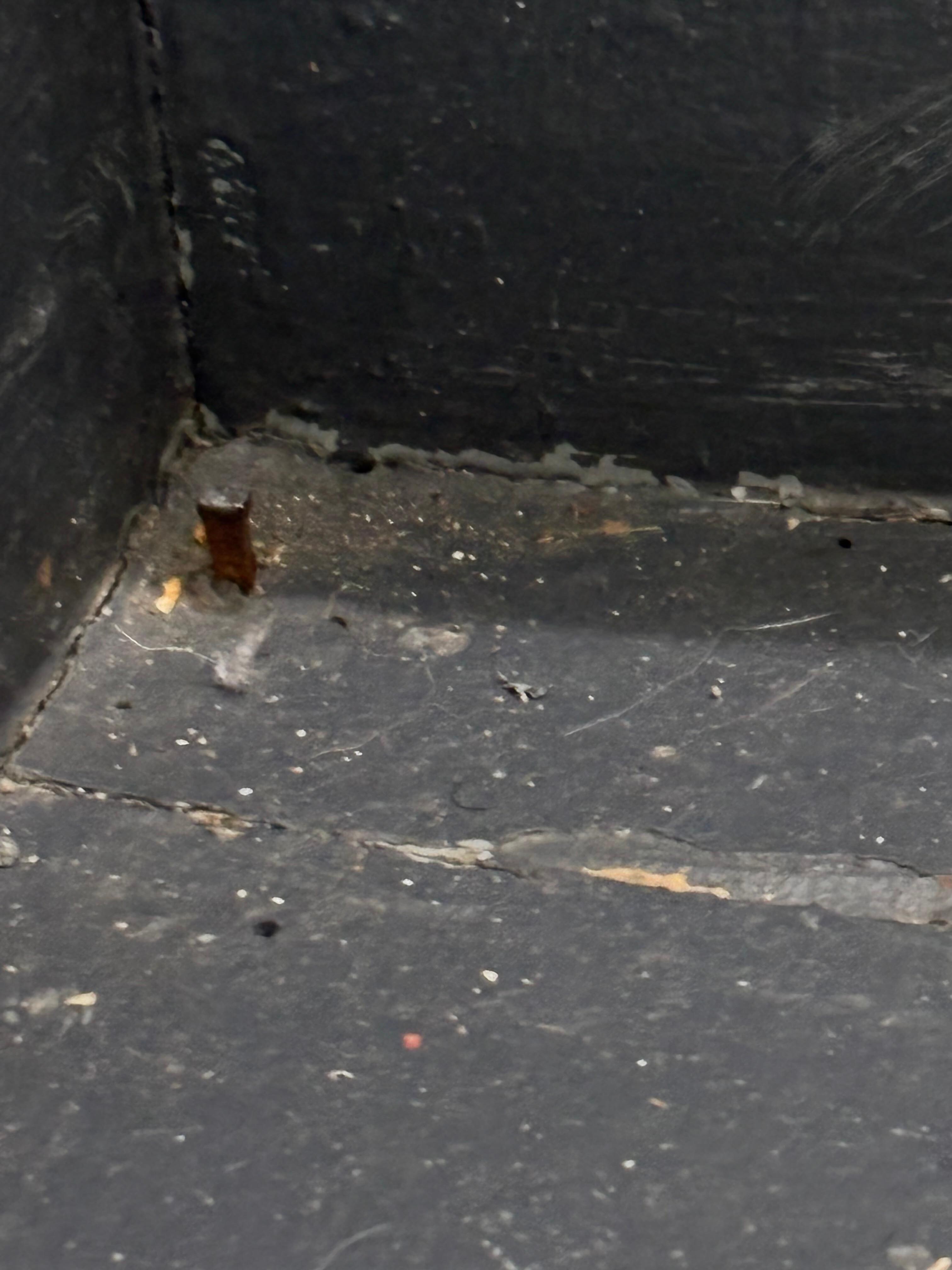 Nail exposed in dark stairwell entrance 