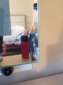 Broken mirror with jagged glass..we put tape over it because there were loose shards. The light in the mirror did not work either.