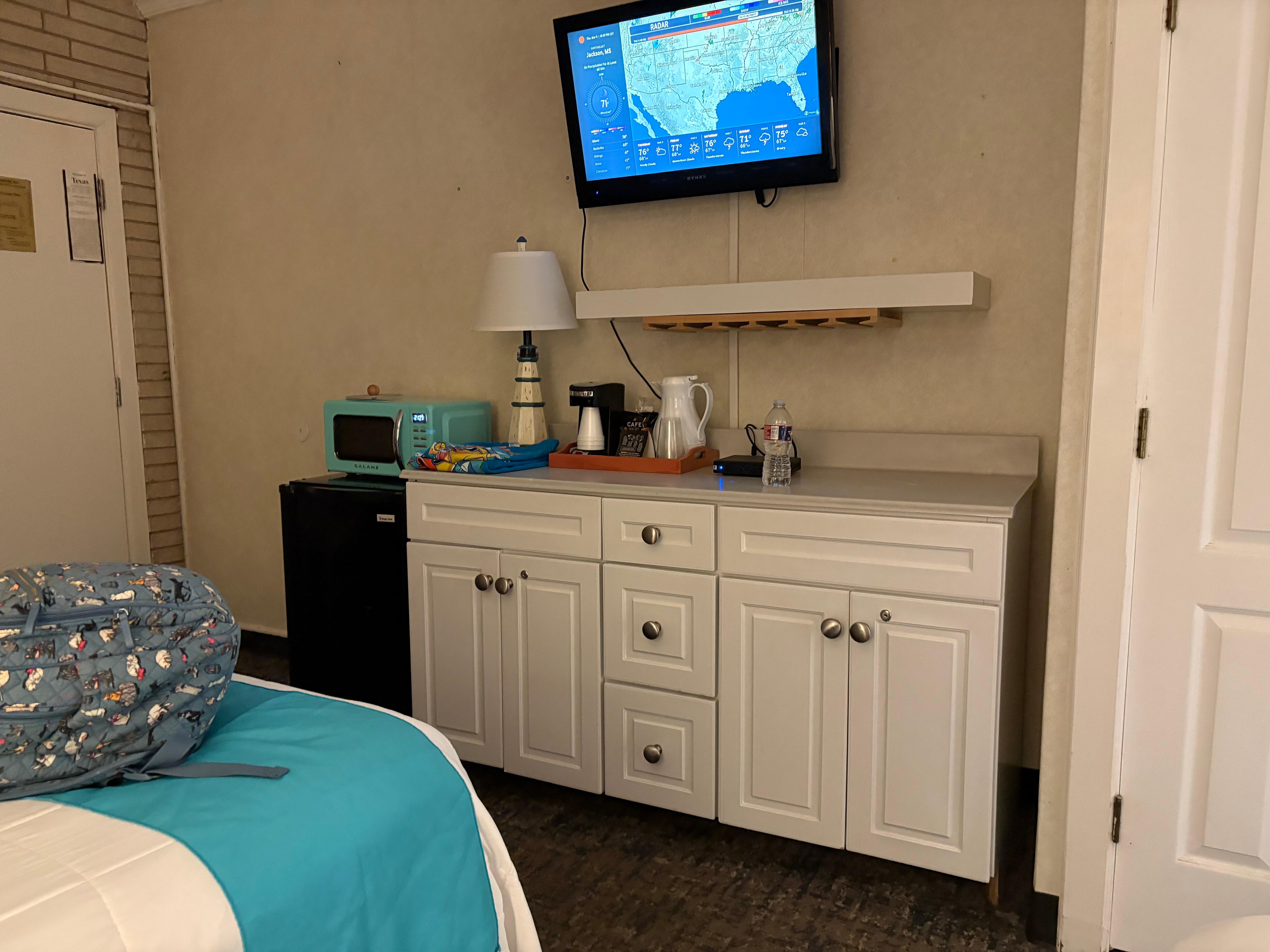 Microwave and refrigerator bar in room 