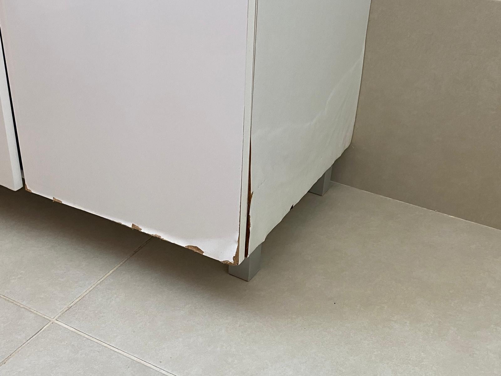 Water damaged sink cabinet, same in all bathrooms.