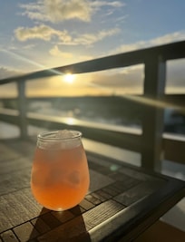 Evening cocktail at sunsetfrom the balcony.
