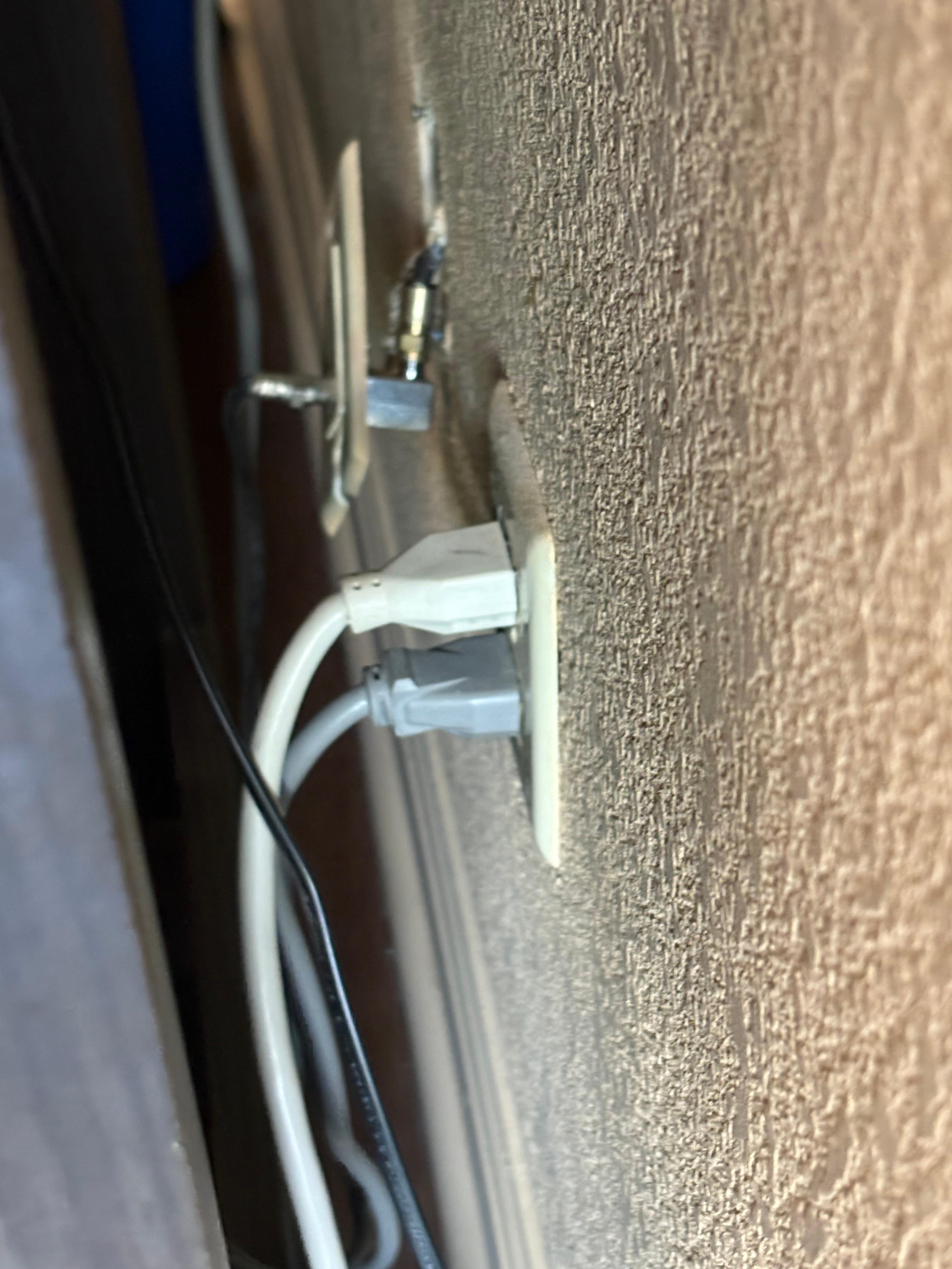 Outlet behind TV and refrigerator