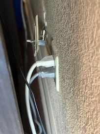 Outlet behind TV and refrigerator
