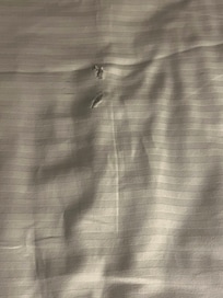 Holes in Sheets. Looks like someone stabbed a knife into the sheets.