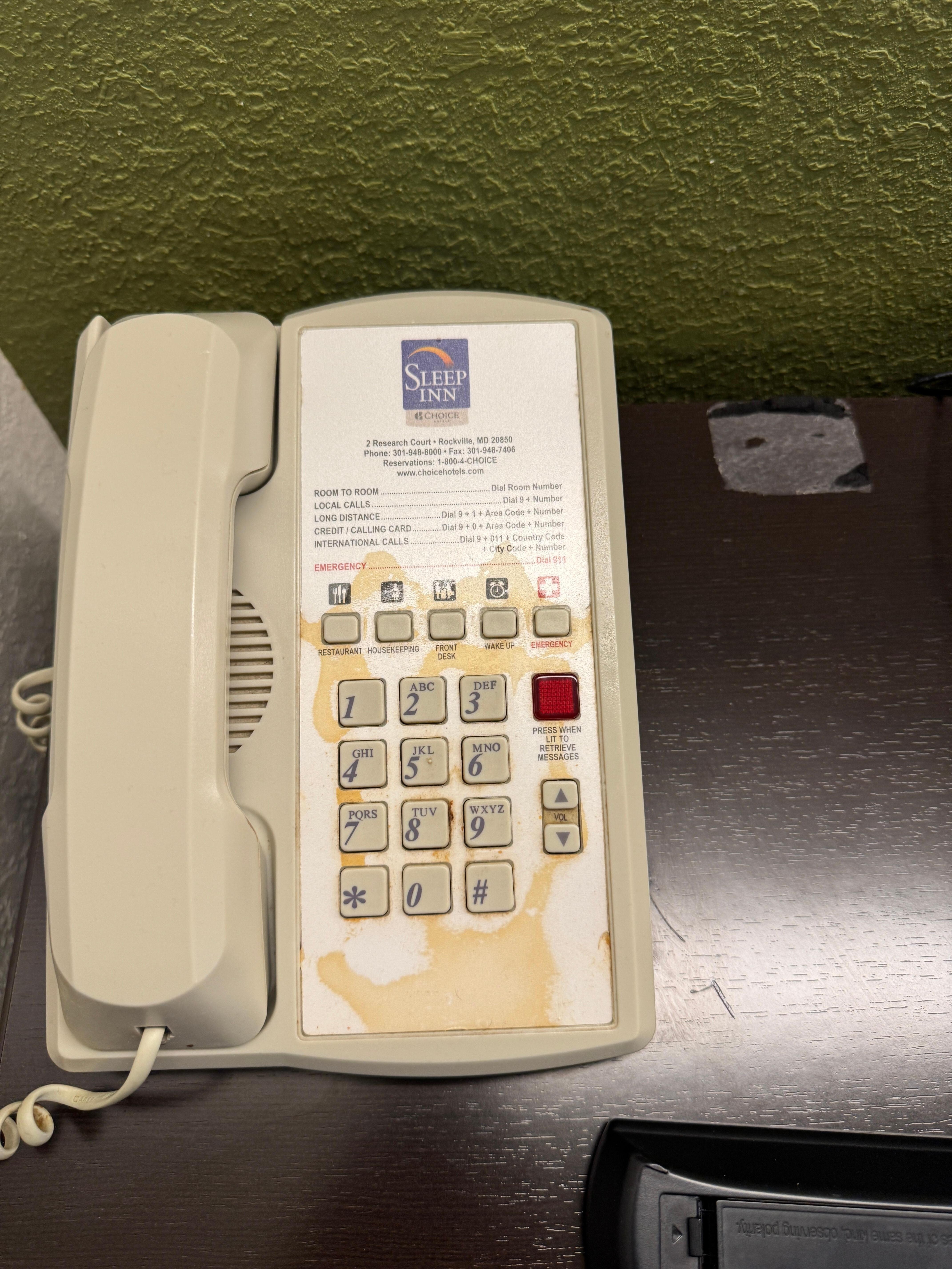Something had been spilled on the phone. Not sure what used to sit next to it on the nightstand (sticky residue)