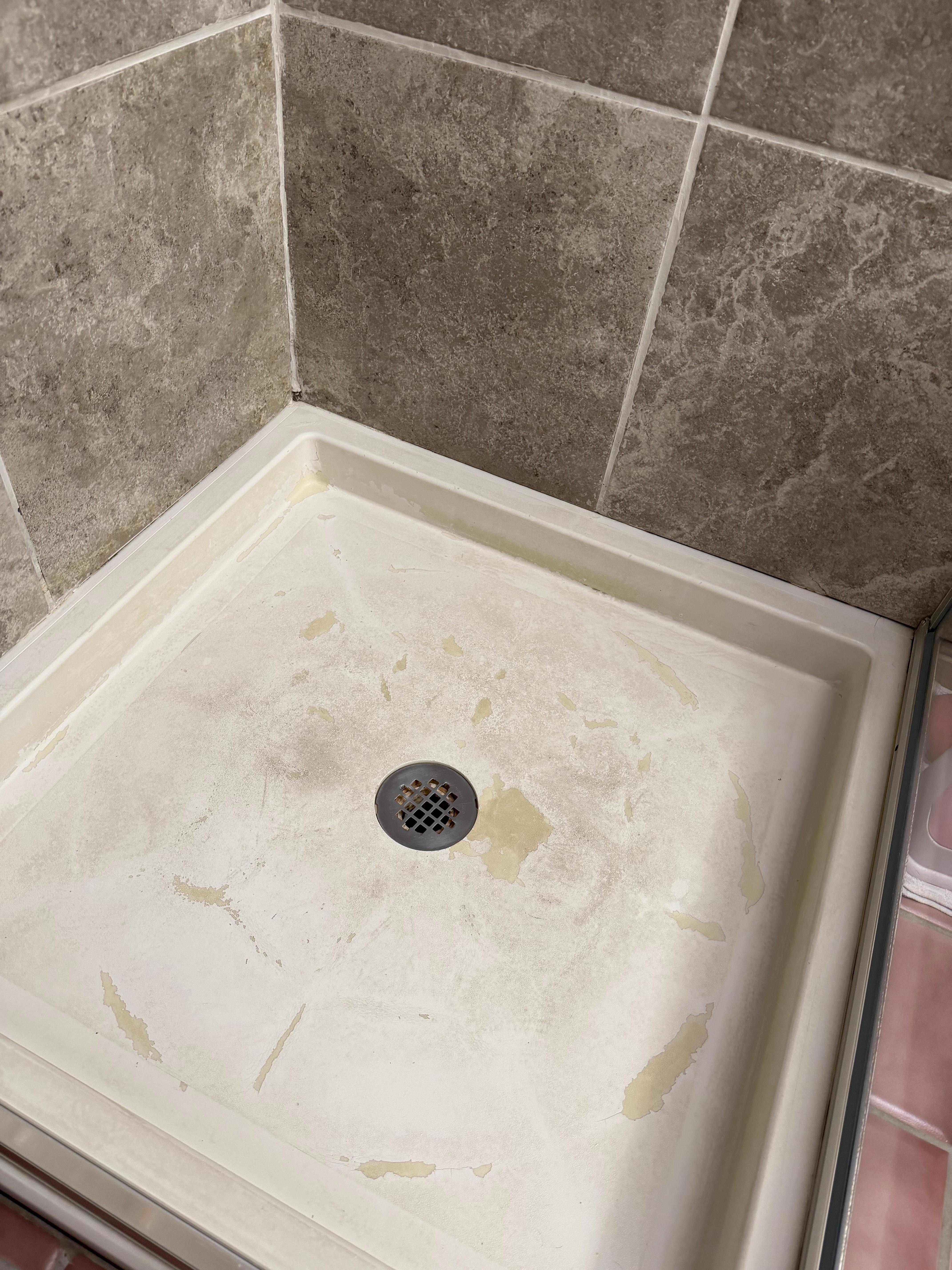 Old and filthy and corroded shower pan 