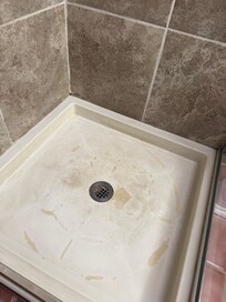 Old and filthy and corroded shower pan