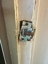 Broken strike plate on front door