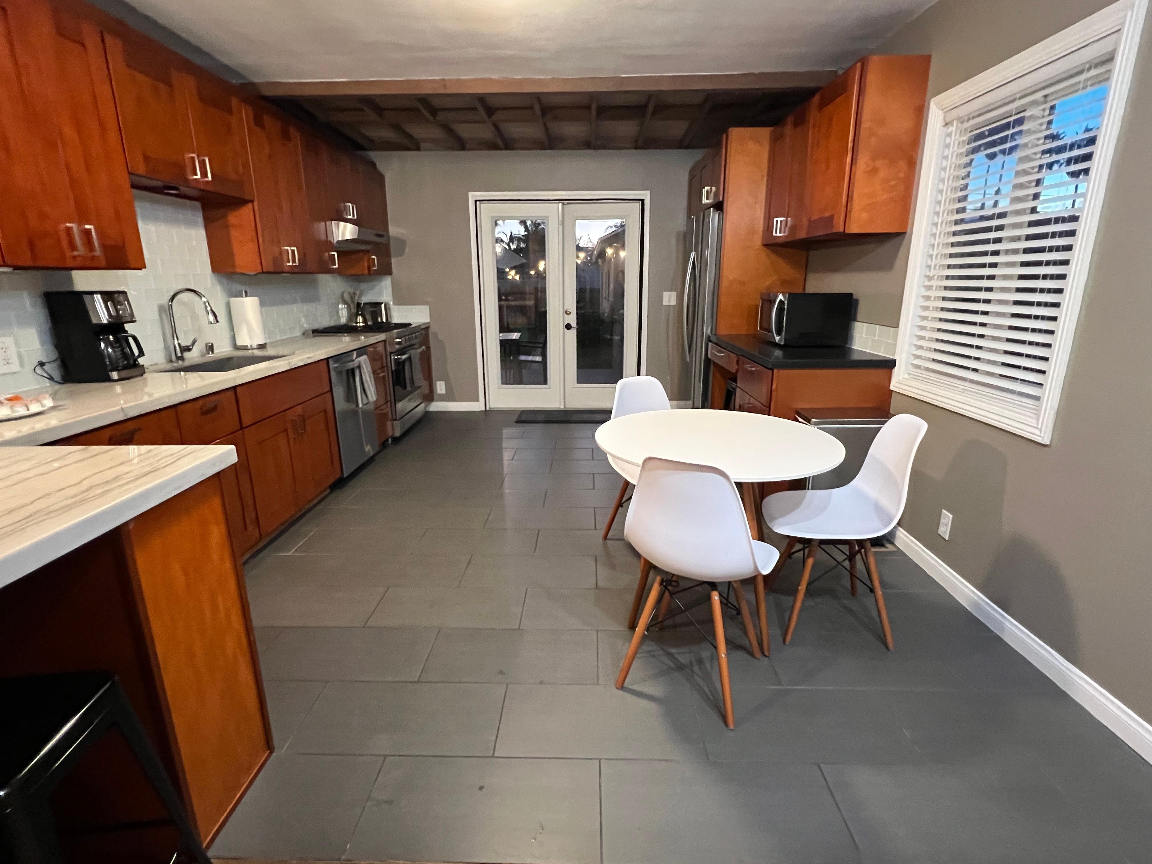 View from door to kitchen to door to back yard