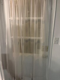 Back door in kitchen. Curtains see through No privacy. And door hard to open in case it was an emergency