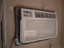 Old heat/air unit in old room.