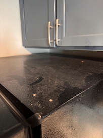 Dirty fridge with dead roach