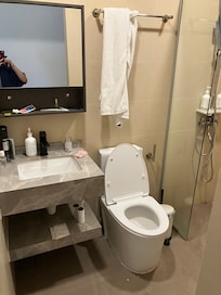 Clean bathroom, just some construction cement accumulate at the corner.