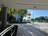 Standing at the front of the hotel.