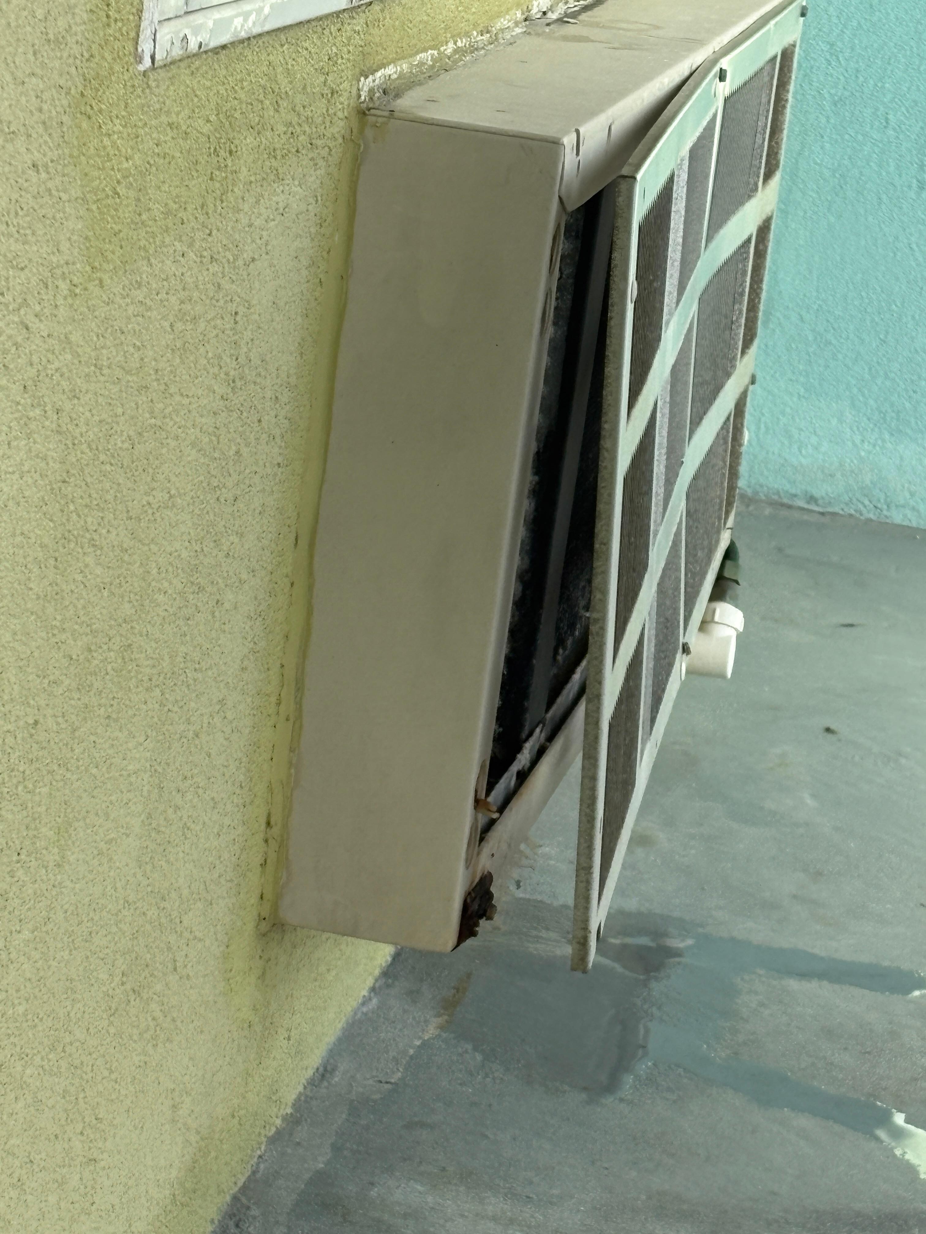 Janky air conditioner leaking condensation all over the balcony.