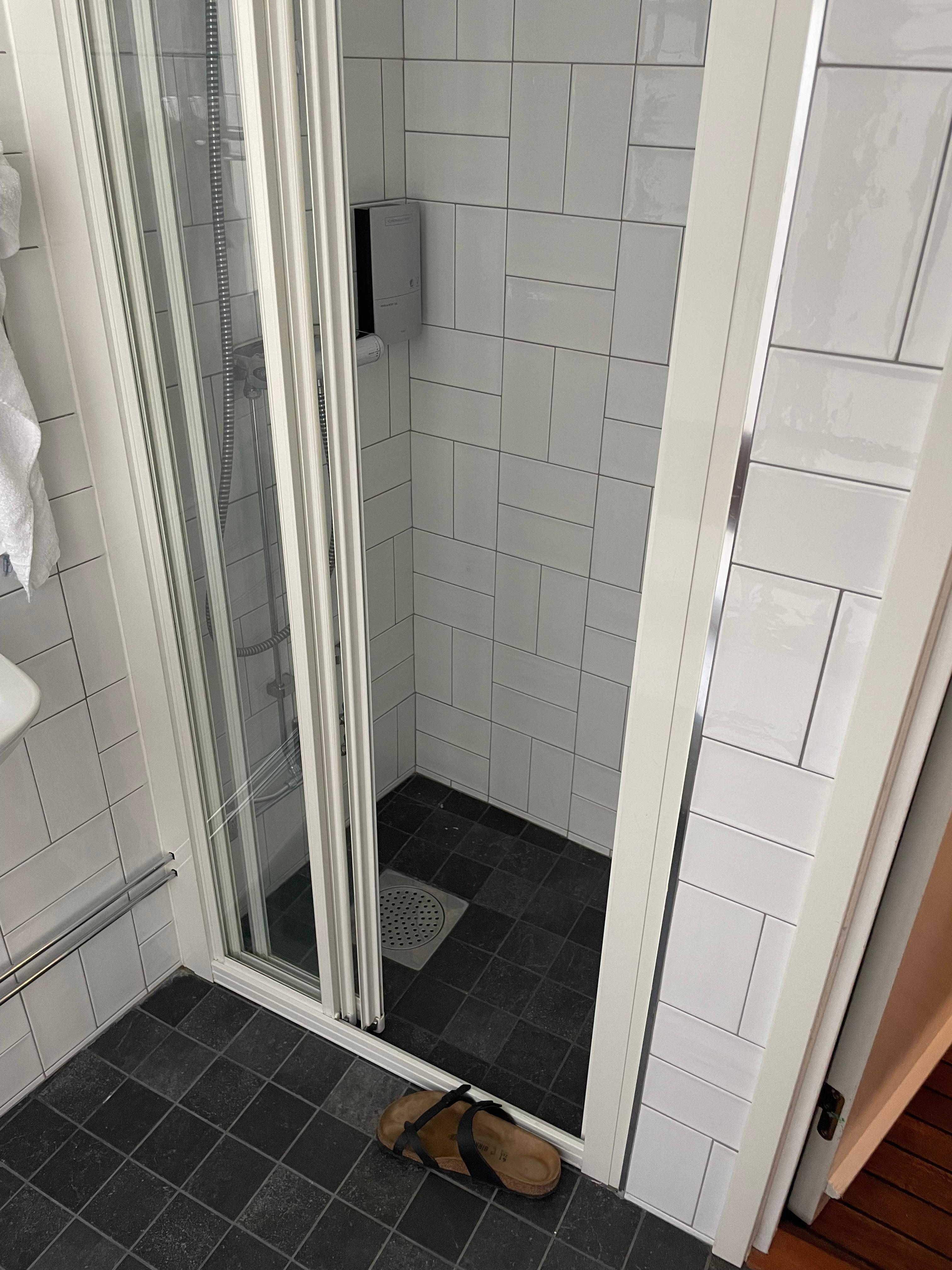 Shoe in photo for size comparison. Small shower but sufficient. 