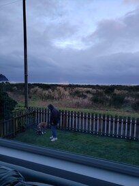 Front yard with ocean view & view from living room window