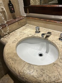 Bathroom mirror is old and the wood is splitting