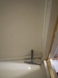 Mildew and your provided a squeegee since the water doesn’t drain!