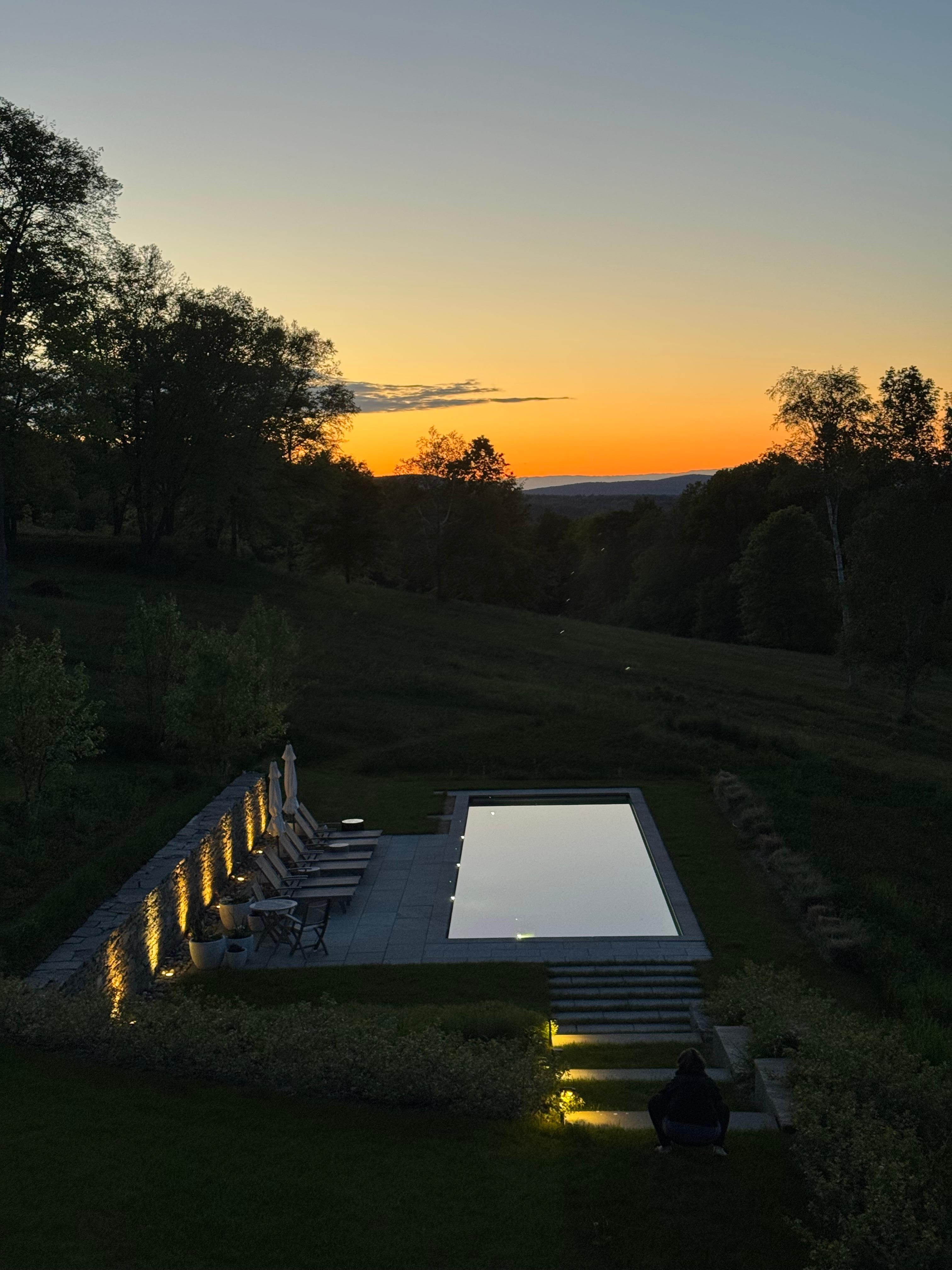 view of pool at sunset from the great room.