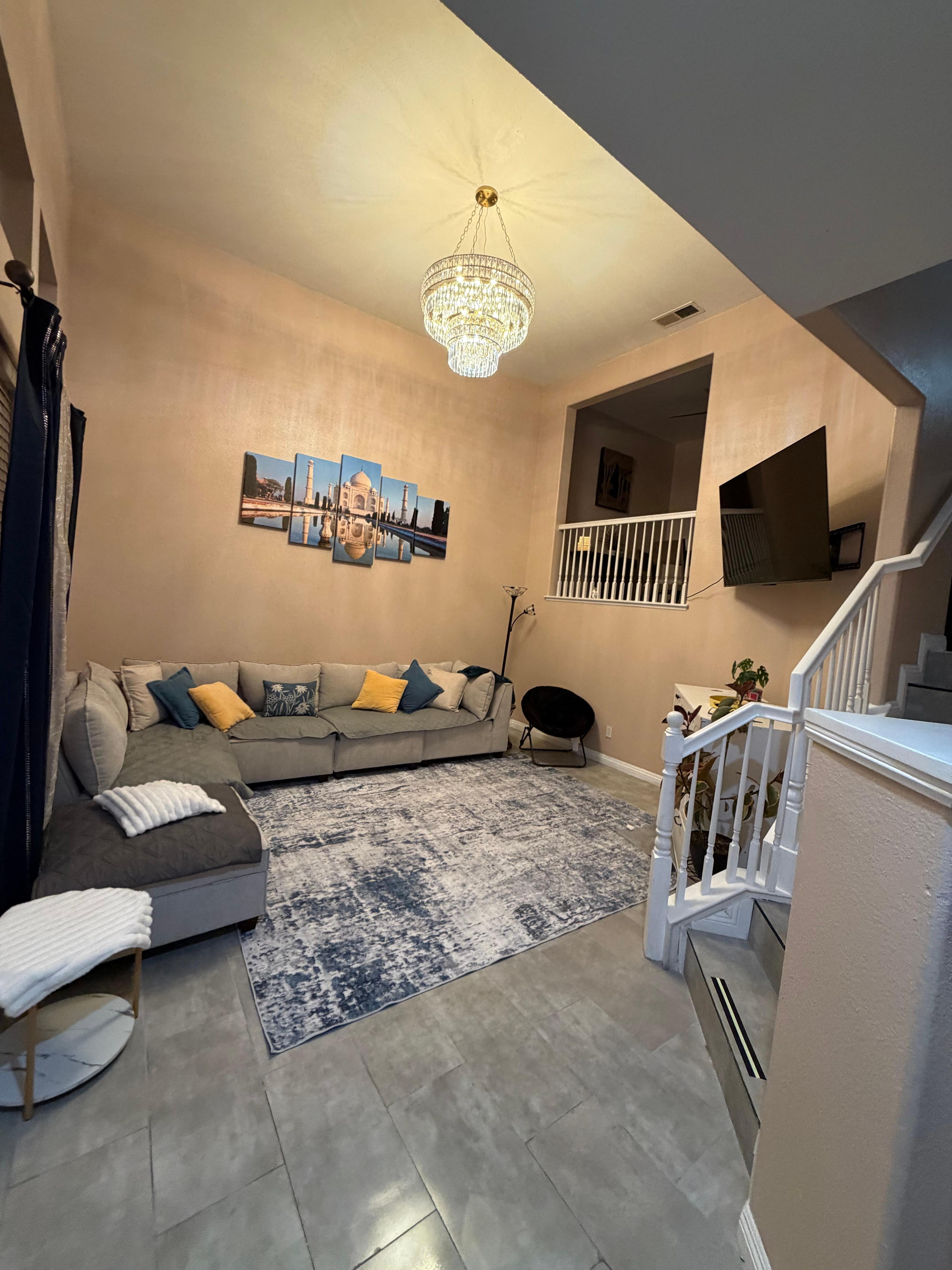 Very spacious living room with a 70” TV