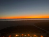 Sunset looking out at beach from balcony.