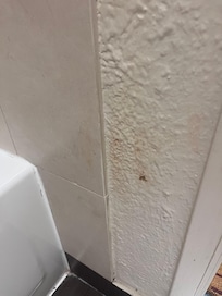 Burn marks on bathroom wall