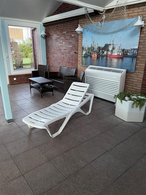 Kleine Lounge mit Tisch und Liegen im Poolbereich