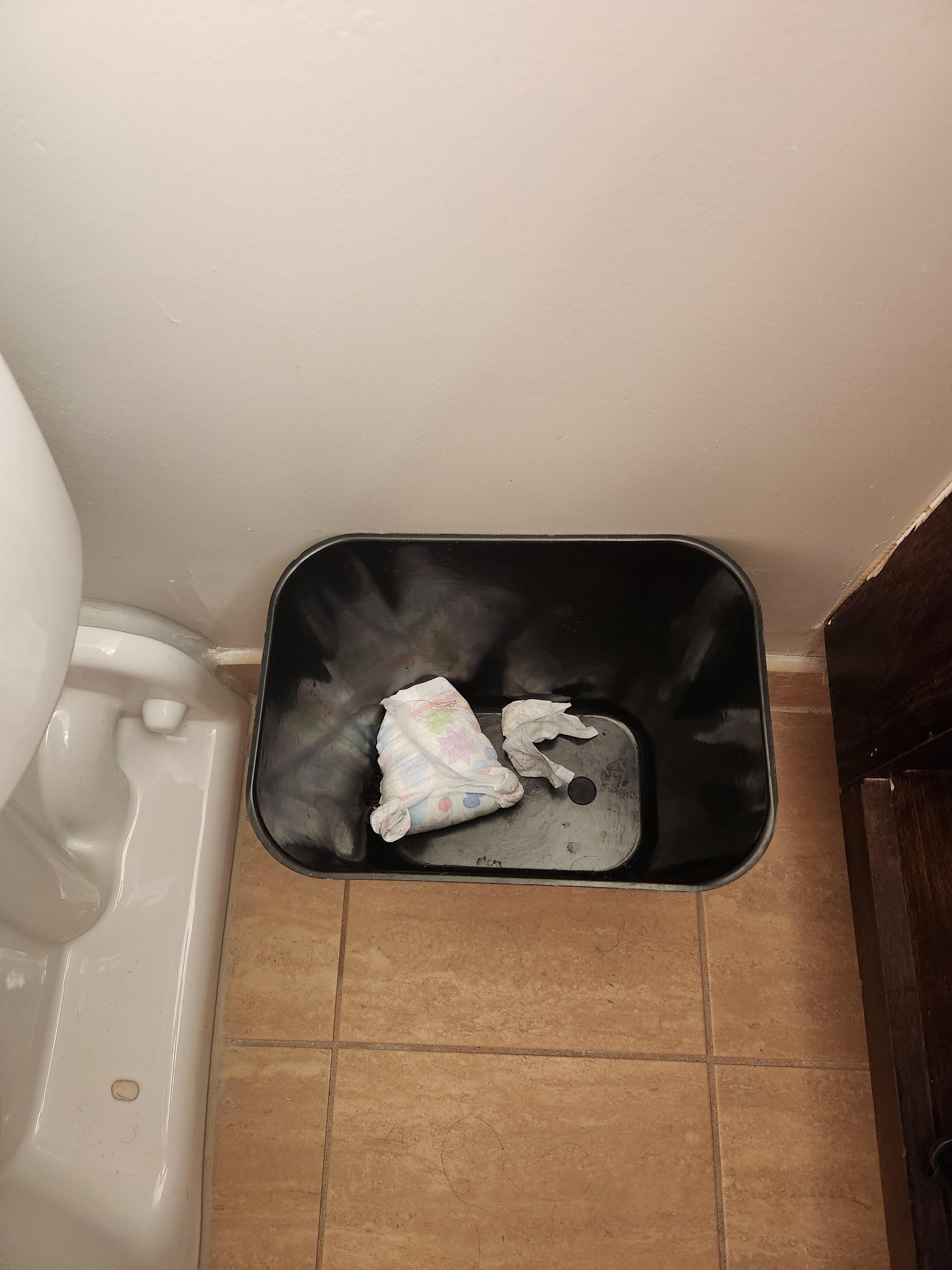 Diaper in bathroom garbage