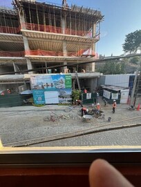 Taken from the apartment. Only 30% of the construction project is shown in the photo. This jobsite is immediately across a very narrow street.