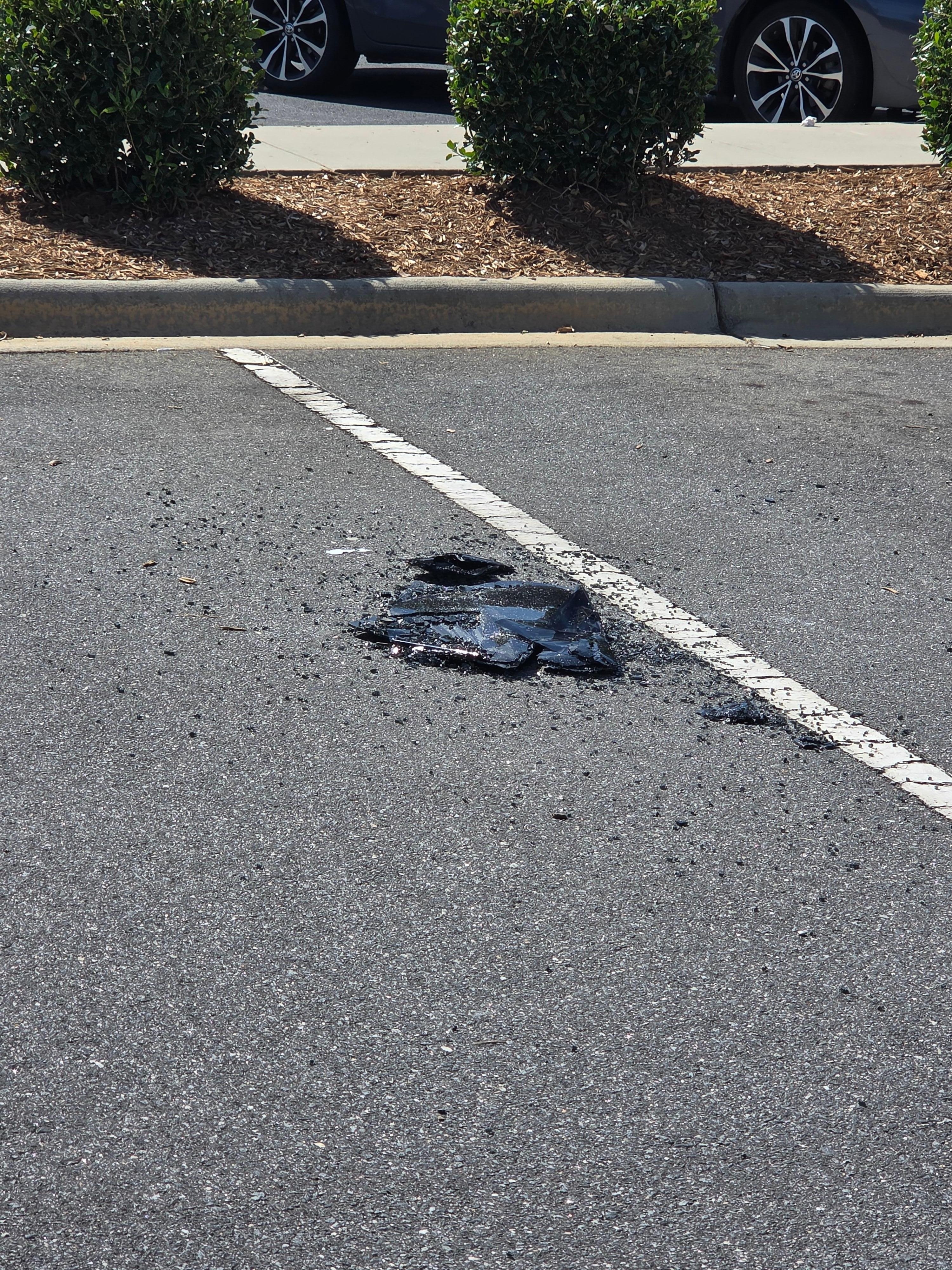 Smashed window in parking lot.