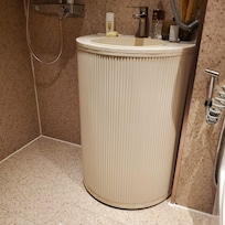 Bottom rust from shower design on newly renovated sink stands.