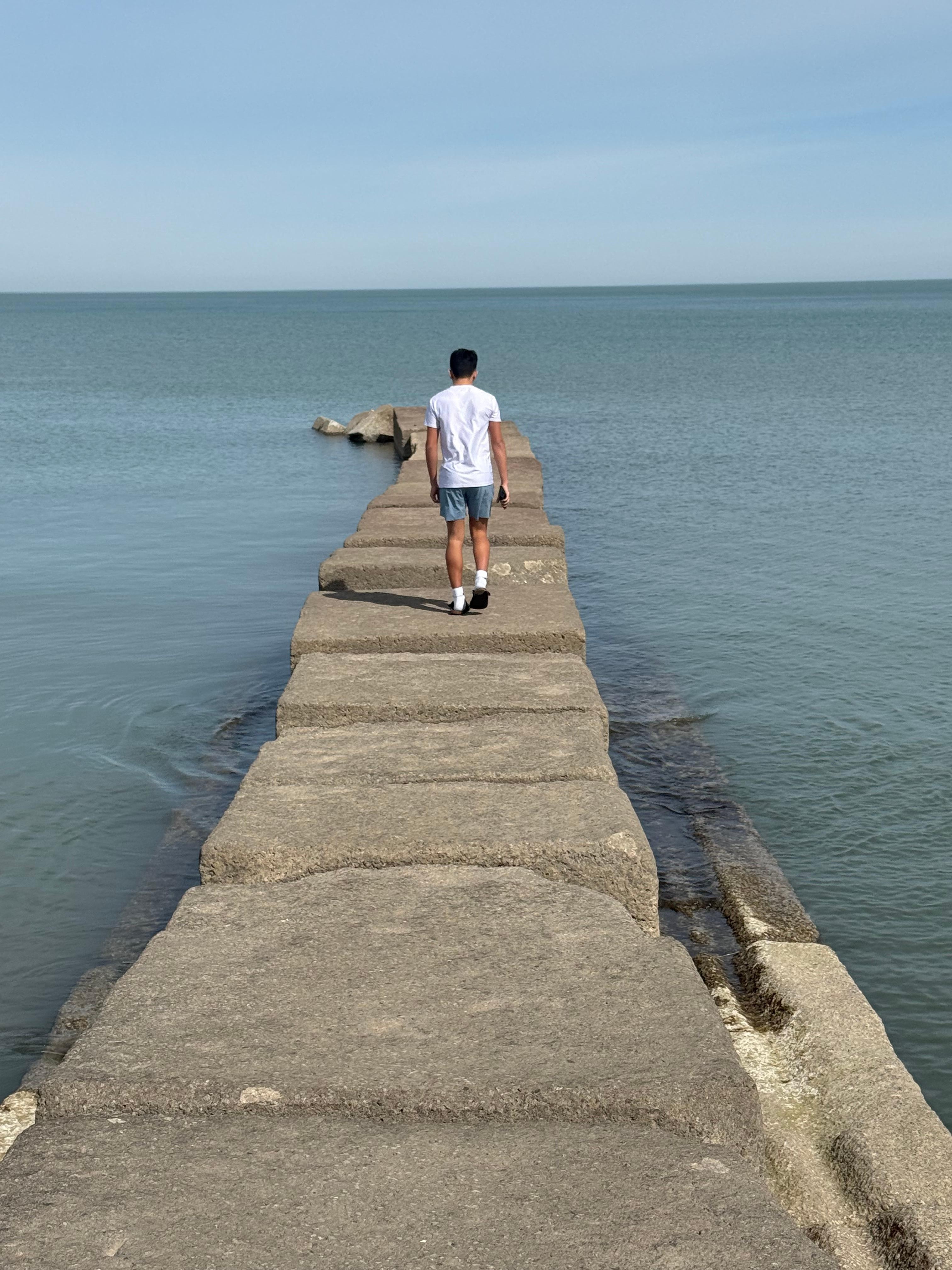 My son standing at the end of the pier