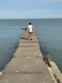 My son standing at the end of the pier