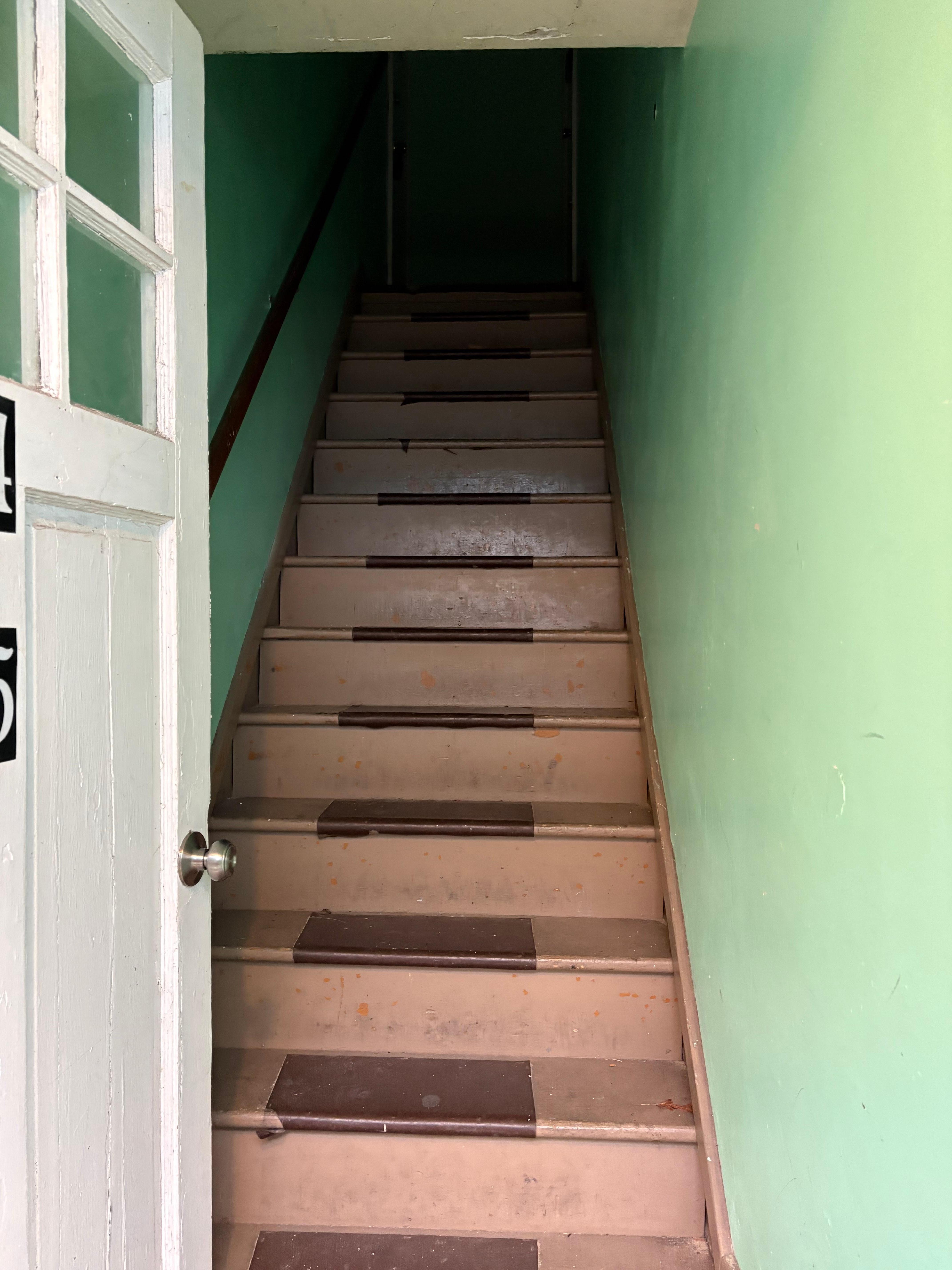 The hall way in daylight is dark. No lighting