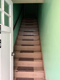 The hall way in daylight is dark. No lighting