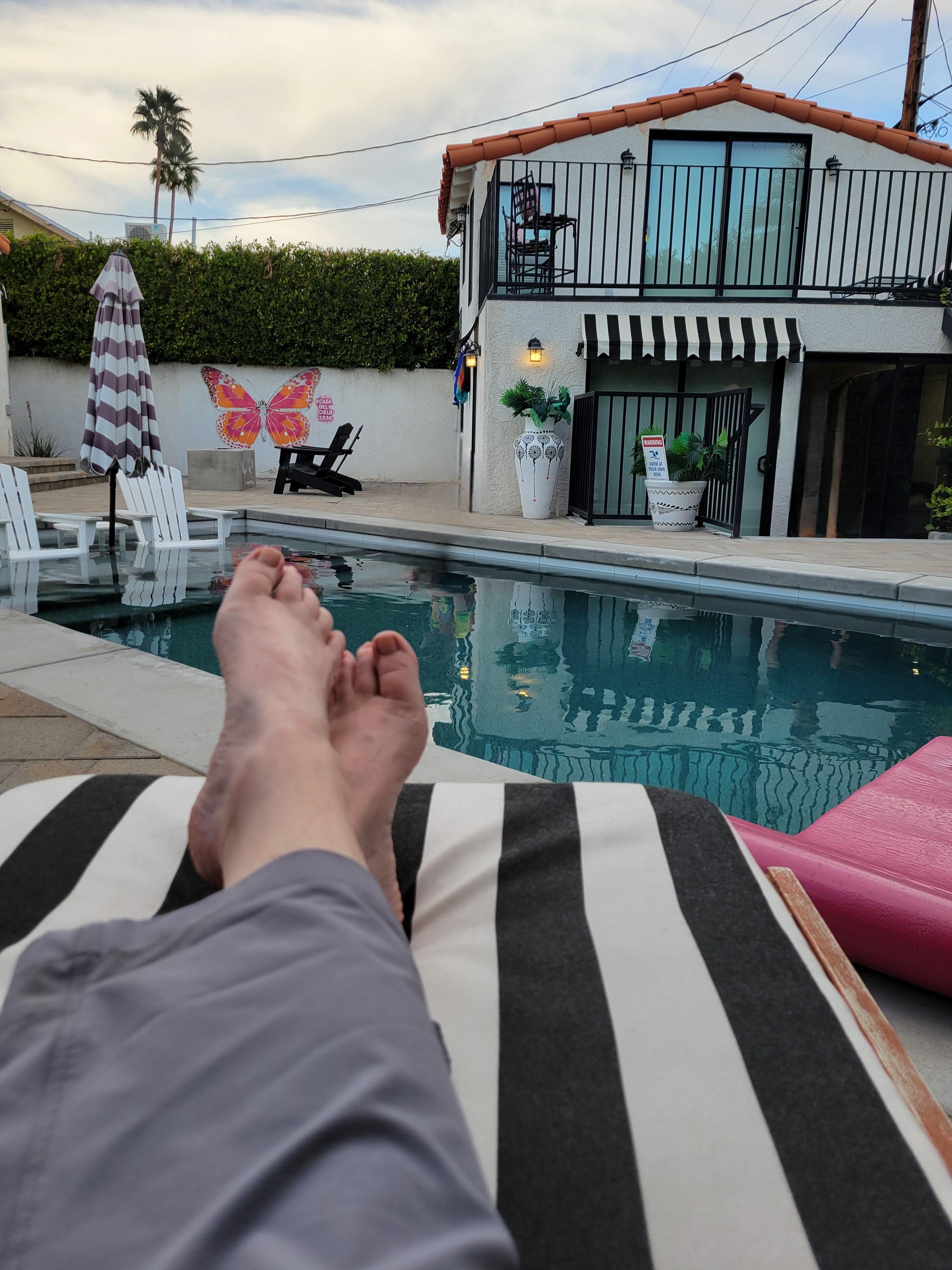 Relaxing by the pool with view of casita