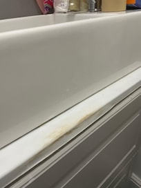 Horrible brown stain at the front of the basin
