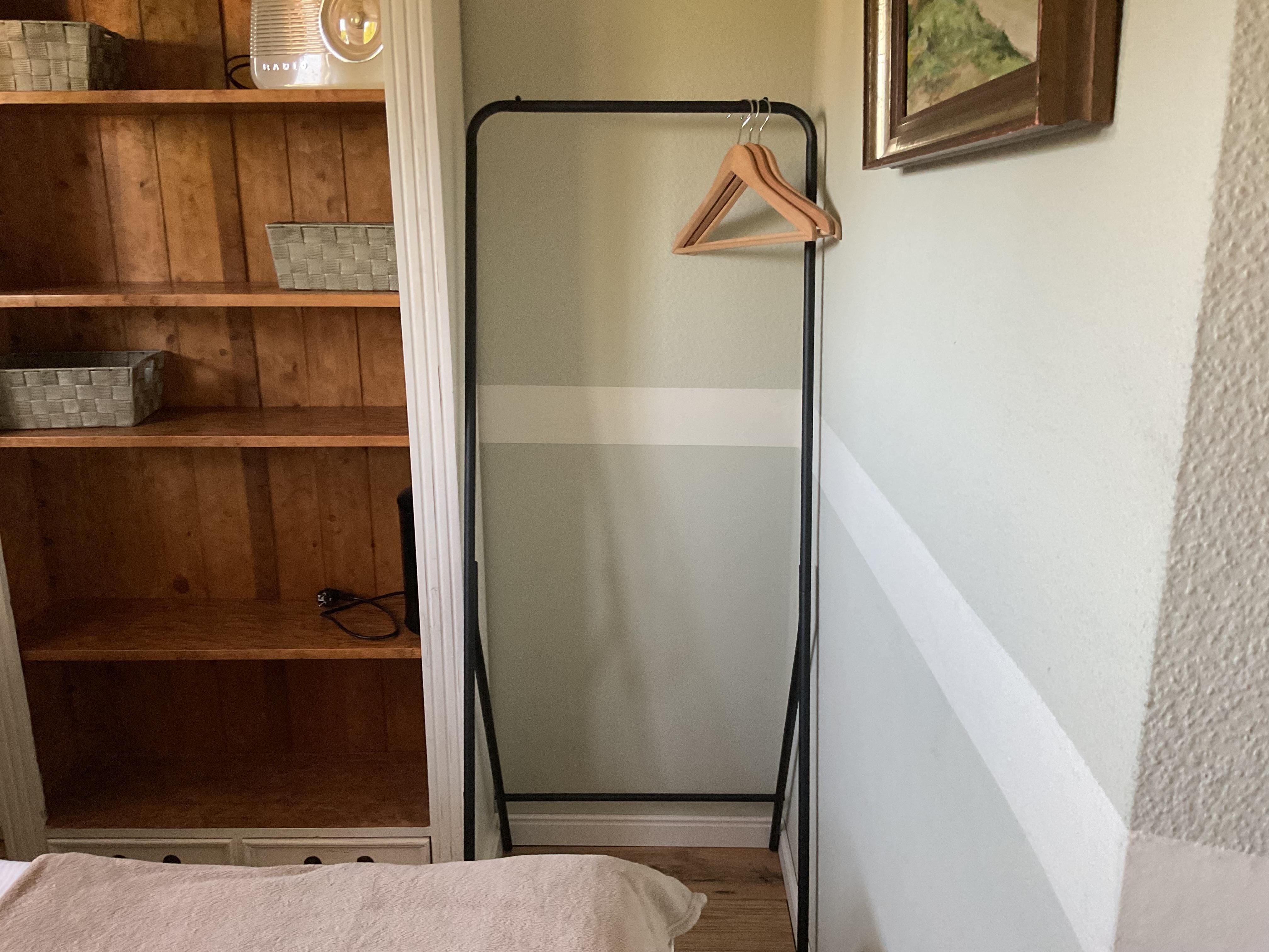 Der sogenannte Schrank als Kleiderständer wäre nur über das Bett erreichbar